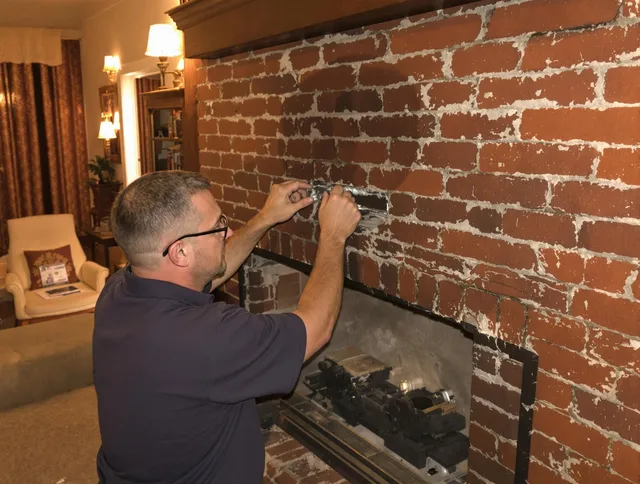 Twinsburg Chimney Sweep expert fixing a fireplace in Twinsburg, OH